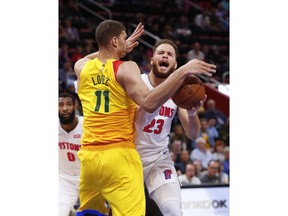 Milwaukee Bucks center Brook Lopez (11) fouls Detroit Pistons forward Blake Griffin (23) in the second half of an NBA basketball game in Detroit, Monday, Dec. 17, 2018.