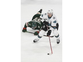 San Jose Sharks' Tomas Hertl of Czech Republic controls the puck after Minnesota Wild's Nino Niederreiter of Switzerland falls in the first period of an NHL hockey game Tuesday, Dec. 18, 2018, in St. Paul, Minn.