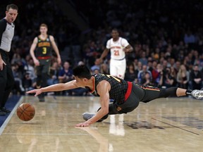 Atlanta Hawks guard Jeremy Lin attempts to save the ball from going out of bounds during the second half of the team's NBA basketball game against the New York Knicks, Friday, Dec. 21, 2018, in New York. The Hawks won 114-107.