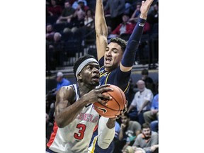 Mississippi's Terence Davis (3) drives the lane against Chattanooga's Jonathan Scott during an NCAA college basketball game in Oxford, Miss., Sunday, Dec. 16, 2018.