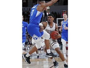 Mississippi State guard T.J. Gray (4) tries to dribble past Brigham Young guard Jahshire Hardnett (0) in the first half of an NCAA college basketball game in Starkville, Miss., Saturday, Dec. 29, 2018.