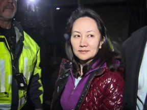 This TV image provided by CTV to AFP shows Huawei Technologies Chief Financial Officer Meng Wanzhou as she exits the court registry following the bail hearing at British Columbia Superior Courts in Vancouver, British Columbia on December 11, 2018.