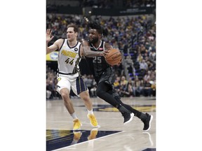 Detroit Pistons guard Reggie Bullock (25) drives on Indiana Pacers forward Bojan Bogdanovic (44) during the first half of an NBA basketball game in Indianapolis, Friday, Dec. 28, 2018.