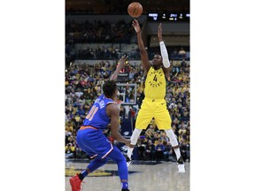 Indiana Pacers guard Victor Oladipo (4) shoots while defended by New York Knicks guard Frank Ntilikina during the second half of an NBA basketball game, Sunday, Dec. 16, 2018, in Indianapolis.