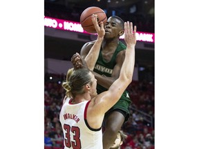 Loyola of Maryland's Isaiah Hart, right, collides with North Carolina State's Wyatt Walker (33) in the lane during the first half of an NCAA college basketball game in Raleigh, N.C., Friday, Dec. 28, 2018.