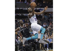 Charlotte Hornets' Kemba Walker (15) drives past Detroit Pistons' Reggie Jackson (1) during the first half of an NBA basketball game in Charlotte, N.C., Wednesday, Dec. 12, 2018.