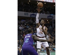 Cleveland Cavaliers' David Nwaba (12) shoots over Charlotte Hornets' Marvin Williams (2) during the first half of an NBA basketball game in Charlotte, N.C., Wednesday, Dec. 19, 2018.