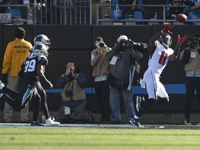 Atlanta Falcons' Julio Jones (11) catches a touchdown pass past Carolina Panthers' Mike Adams (29) during the first half of an NFL football game in Charlotte, N.C., Sunday, Dec. 23, 2018.