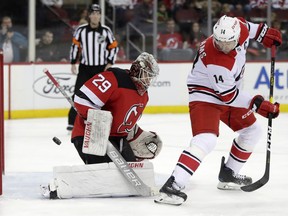 New Jersey Devils goaltender MacKenzie Blackwood (29) blocks a shot from Carolina Hurricanes right wing Justin Williams (14) during the first period of an NHL hockey game, Saturday, Dec. 29, 2018, in Newark, N.J.