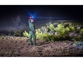 FILE - In this June 24, 2015, file photo, a Border Patrol agent looks for other agents in the Animas mountains in New Mexico's boot heel. A 7-year-old Guatemalan girl, picked up with her father and dozens of other migrants along the remote stretch of the U.S.-Mexico border, has died, federal officials said Friday, Dec. 14, 2018.