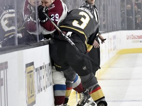 Colorado Avalanche center Nathan MacKinnon (29) is checked by Vegas Golden Knights defenseman Brayden McNabb during the first period of an NHL hockey game Thursday, Dec. 27, 2018, in Las Vegas.