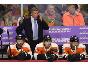 FILE - In this Nov. 27, 2018, file photo, Philadelphia Flyers head coach Dave Hakstol watches from the bench during an NHL hockey game against the Ottawa Senators, in Philadelphia. The Flyers fired head coach Dave Hakstol Monday, Dec. 17, 2018.