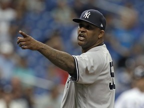 FILE - In this Sept. 27, 2018, file photo, New York Yankees' CC Sabathia points at the Tampa Bay Rays dugout after he was ejected for hitting Tampa Bay Rays' Jesus Sucre with a pitch during the sixth inning of a baseball game, in St. Petersburg, Fla. The New York Yankees gave pitcher CC Sabathia a $500,000 performance bonus, even though the 38-year-old left-hander was ejected from his final regular-season start six outs shy of the 155 innings specified for the payment in his contract.