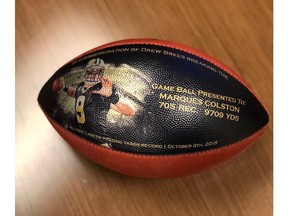 This undated photo provided by the New Orleans Saints shows a custom made football. When Drew Brees became the NFL's all-time leader in yards passing, he wanted to come up with some sort of gift to thank those who coached him, caught the 6,357 completions it took to set the record, and those who blocked while he threw. His solution was an exhaustive process than involved the production of about 175 unique commemorative footballs and the enlisting Saints front office and public relations staff to help track down 99 receivers, 56 offensive linemen, 11 head or assistant coaches from his 18 pro seasons, as well as a few others Brees saw as instrumental in his success. (New Orleans Saints via AP)