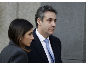 Michael Cohen, right, President Donald Trump's former lawyer, arrives at federal court for his sentencing for dodging taxes, lying to Congress and violating campaign finance laws in New York on Wednesday, Dec. 12, 2018.