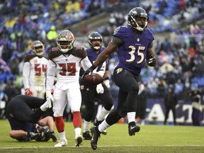 FILE - In this Dec. 16, 2018, file photo, Baltimore Ravens running back Gus Edwards (35) scores a touchdown in the second half of an NFL football game against the Tampa Bay Buccaneers in Baltimore. After playing three seasons at Miami and transferring to Rutgers for his final year of eligibility, Edwards signed a three-year contract with the Ravens in May.