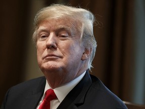 FILE - In this Dec. 13, 2018, file photo, President Donald Trump listens during a meeting in the Cabinet Room of the White House in Washington. New York Attorney General Barbara Underwood and Trump's charitable foundation reached a deal on Tuesday, Dec. 18, 2018, to dissolve the foundation and distribute its remaining assets to other nonprofit groups.