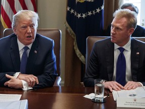 FILE - In this April 9, 2018, file photo, Deputy Secretary of Defense Patrick Shanahan, right, listen as President Donald Trump speaks during a cabinet meeting at the White House, in Washington. A U.S. administration official says that Defense Secretary Jim Mattis will leave his post Jan. 1, 2019, as Trump is expected to name Shanahan as acting secretary.