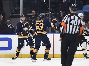 Buffalo Sabres defenseman Marco Scandella, left, celebrates his goal with left wing Jeff Skinner (53) during the first period of an NHL hockey game against the Boston Bruins in Buffalo, N.Y., Saturday, Dec. 29, 2018.