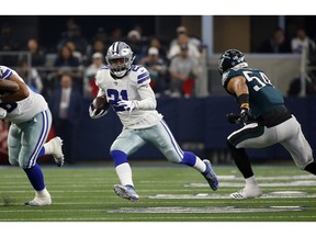 FILE - In this Sunday, Dec. 9, 2018, file photo, Dallas Cowboys running back Ezekiel Elliott (21) runs against the Philadelphia Eagles during the first half of an NFL football game in Arlington, Texas. If the Cowboys are for real, they will win their sixth straight game and clinch the NFC East at Indianapolis on Sunday.