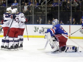 New York Rangers goaltender Henrik Lundqvist (30) watches as the Columbus Blue Jackets celebrate a goal by Oliver Bjorkstrand, left, during the first period of an NHL hockey game Thursday, Dec. 27, 2018, in New York.
