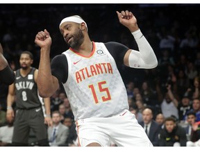 Atlanta Hawks' Vince Carter (15) celebrates after scoring during the first half of an NBA basketball game against the Brooklyn Nets, Sunday, Dec. 16, 2018, in New York.