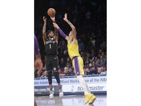 Brooklyn Nets' D'Angelo Russell (1) shoots over Los Angeles Lakers' Kyle Kuzma (0) during the second half of an NBA basketball game Tuesday, Dec. 18, 2018, in New York. The Nets won 115-110.