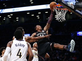 Brooklyn Nets' Rondae Hollis-Jefferson is fouled on his way to the basket by Indiana Pacers' Thaddeus Young during the second half of an NBA basketball game, Friday, Dec. 21, 2018, in New York.
