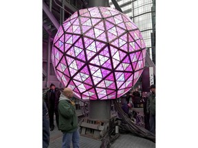 Workers in New York's Times Square perform a test on Sunday, Dec. 30, 2018, of the New Year's Eve ball that will be lit and sent up a 130-foot pole atop One Times Square to mark the start of the 2019 new year. Organizers of the annual event say the ball, illuminated by LEDs and enhanced by Waterford Crystal triangles, is capable of displaying a palette of more than 16 million vibrant colors and billions of patterns to create a spectacular kaleidoscope effect.