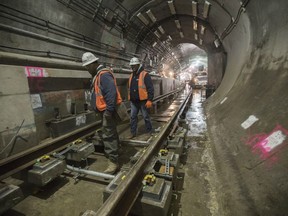 In this Nov. 29, 2018 photo, a construction crew works on the tracks of the East Side Access project beneath Grand Central Terminal in New York. The super-pricey railroad hub is taking shape, dogged by billion-dollar cost overruns and a decade of delays, but still impressive as an engineering marvel.