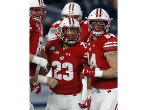 Wisconsin running back Jonathan Taylor (23) celebrates with teammates after scoring a touchdown during the first half of the Pinstripe Bowl NCAA college football game against Miami on Thursday, Dec. 27, 2018, in New York.