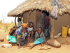 A woman demonstrates how she ties her two kids suffering from Nodding Syndrome on a rope to minimize their movement. The mysterious disease found only in northern Uganda stunts children and destroys their cognition.