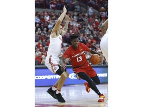 Youngstown State's Donel Cathcart, right, drives to the basket as Ohio State's Duane Washington defends during the first half of an NCAA college basketball game Tuesday, Dec. 18, 2018, in Columbus, Ohio.