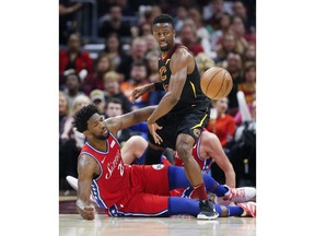 Cleveland Cavaliers' David Nwaba (12) and Philadelphia 76ers' Joel Embiid (21), from Cameroon, battle for the ball during the first half of an NBA basketball game Sunday, Dec. 16, 2018, in Cleveland.