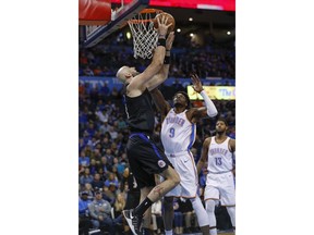 Los Angeles Clippers center Marcin Gortat (13) goes to the basket as Oklahoma City Thunder forward Jerami Grant (9) defends during the first half of an NBA basketball game in Oklahoma City, Saturday, Dec. 15, 2018.