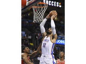 Oklahoma Thunder center Steven Adams (12) goes up for a dunk over Chicago Bulls center Wendell Carter Jr., left, in the first half of an NBA basketball game in Oklahoma City, Monday, Dec. 17, 2018.