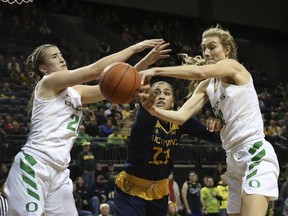 Oregon's Sabrina Ionescu, left, and Lydia Giomi, right, battle UC Irvine's Tahlia Garza, center, for a rebound during the second half of an NCAA college basketball game in Eugene, Ore., Friday Dec. 21, 2018.