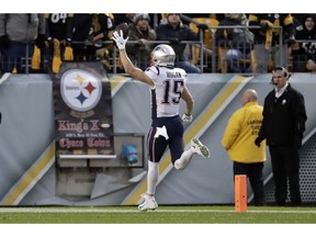 New England Patriots wide receiver Chris Hogan (15) scores after taking a pass from quarterback Tom Brady during the first half of an NFL football game against the Pittsburgh Steelers in Pittsburgh, Sunday, Dec. 16, 2018.