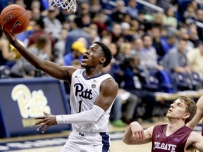 Pittsburgh's Xavier Johnson (1) shoots after getting by Colgate's Rapolas Ivanauskas during the first half of an NCAA college basketball game, Saturday, Dec. 29, 2018, in Pittsburgh.