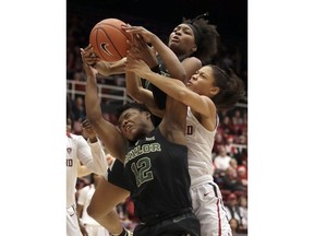 Stanford guard Anna Wilson, right, reaches for a rebound between Baylor forward NaLyssa Smith, top, and guard Moon Ursin (12) during the first half of an NCAA college basketball game in Stanford, Calif., Saturday, Dec. 15, 2018.