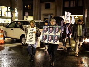Protestors walk on Broad Street to demonstrate for Mumia Abu-Jamal outside the offices of District Attorney Larry Krasner, Friday, Dec. 28, 2018, in Philadelphia. A judge issued a split ruling Thursday that grants Abu-Jamal another chance to appeal his 1981 conviction in a Philadelphia police officer's death.