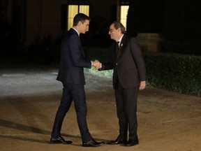 Spain's Prime Minister Pedro Sanchez, left, shakes hands with the president of the country's Catalonia region, Quim Torra before a meeting in Barcelona, Spain, Thursday, Dec. 20, 2018. Prime Minister Sanchez met with Catalonia's regional President Torra, who heads a pro-secession coalition and wants self-determination to be part of the talks.