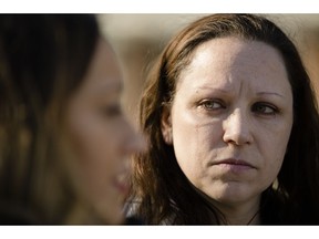 Amanda Spillane, right, listens to Courtney Haveman speak with members of the media during a news conference in Philadelphia, Wednesday, Dec. 12, 2018. Haveman and Spillane who were denied licenses to work as estheticians as a result of running afoul of a state good moral character rule, due to past drug-related convictions, are challenging the regulation in a lawsuit.