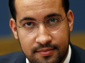 FILE - In this Wednesday, Sept. 19, 2018 file picture former President Macron's security aide Alexandre Benalla appears before the French Senate Laws Commission prior to his hearing, in Paris, France. France's Foreign Ministry is threatening legal action against a former security aide to President Emmanuel Macron, amid reports that he continued using his diplomatic passports after being fired for beating a protester.