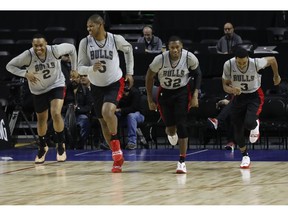 Chicago Bulls Jabari Parker, from left, Cristiano Felicio, Kris Dunn and Shaquille Harrison, warm up at the start of a basketball practice at the Mexico City Arena in Mexico City, Wednesday, Dec. 12, 2018. The Bulls will face Orlando Magic Thursday in the first of two 2018 regular-season NBA games to be played in the high-altitude Mexican capital.
