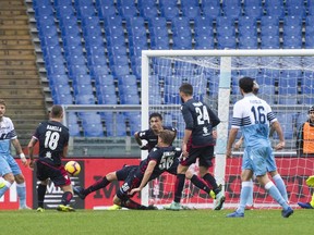 Lazio's Sergej Milinkovic-Savic, left, scores his side's first goal during a soccer match between Lazio and Cagliari, at Rome's Olympic Stadium, Saturday, Dec. 22, 2018.