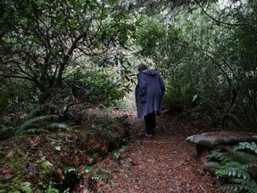 In this Monday, Dec. 10, 2018, photo, Psychologist Hilarie Cash walks on a forest path at a rehab center for adolescents in a rural area outside Redmond, Wash. The complex is part of reSTART Life, a residential program for adolescents and adults who have serious issues with excessive tech use, including video games. Disconnecting from tech and getting outside is part of the rehabilitation process. The organization, which began about a decade ago, also is adding outpatient services due to high demand. Cash is chief clinical officer and a co-founder at reSTART.