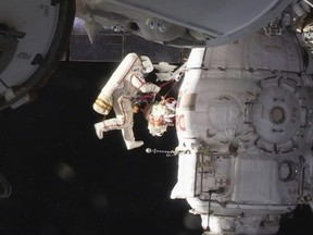 In this image from video made available by NASA, Russian cosmonaut Oleg Kononenko performs a spacewalk outside the International Space Station on Tuesday, Dec. 11, 2018. Kononenko and Sergei Prokopyev are inspecting a section where a mysterious leak appeared on Aug. 30.