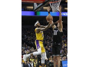 Los Angeles Lakers forward Brandon Ingram (14) shoots as Sacramento Kings forward Nemanja Bjelica (88) defends during the first half of an NBA basketball game in Sacramento, Calif., Thursday, Dec. 27, 2018.