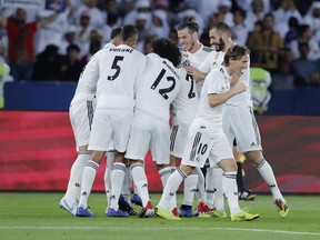 Real Madrid's players celebrate after scoring during the Club World Cup final soccer match between Real Madrid and Al Ain at Zayed Sport City in Abu Dhabi, United Arab Emirates, Saturday, Dec. 22, 2018.